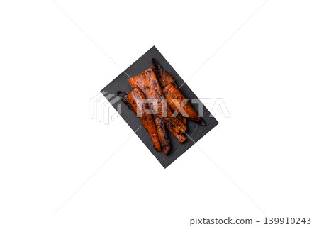 Grilled or barbecued carrot slices with salt and spices. Grilled carrots Grilled or barbecued carrot slices with salt and spices. Grilled carrots 139910243