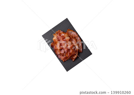 Fried fresh bacon slices with layers of meat or prosciutto with salt and spices. Fried bacon Fried fresh bacon slices with layers of meat or prosciutto with salt and spices. Fried bacon 139910260