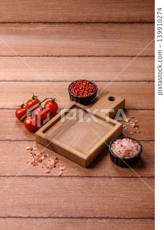 Empty wooden cutting board for preparing ingredients for home cooking. An empty cutting board Empty wooden cutting board for preparing ingredients for home cooking. An empty cutting board 139910274