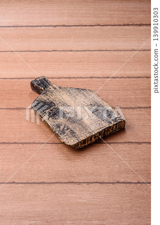 Empty wooden cutting board for preparing ingredients for home cooking. An empty cutting board Empty wooden cutting board for preparing ingredients for home cooking. An empty cutting board 139910303