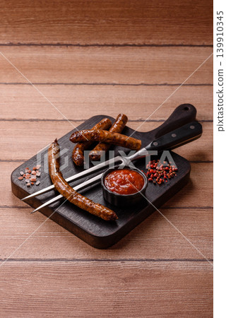 Thin chicken or pork sausages grilled or barbecued. Grilled sausages 139910345