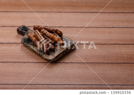 Thin chicken or pork sausages grilled or barbecued. Grilled sausages 139910356