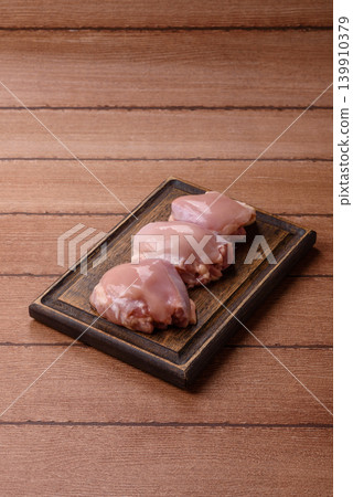 Raw chicken thigh fillet, boneless and skinless, for roasting. Raw thigh fillet Raw chicken thigh fillet, boneless and skinless, for roasting. Raw thigh fillet 139910379