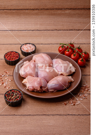 Raw chicken thigh fillet, boneless and skinless, for roasting. Raw thigh fillet 139910386