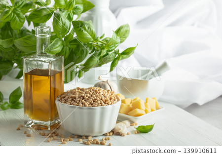 Ingredients for making Pesto sauce on a white wooden table. Ingredients for making Pesto sauce on a white wooden table. 139910611