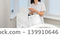 Female cosmetologist operating modern laser beauty equipment 139910646