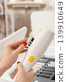 Close-up of a cosmetologist changing a cartridge on a modern laser handpiece 139910649