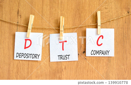 DTC depository trust company symbol. Concept words DTC depository trust company on beautiful white papers. Beautiful wooden background. Business DTC depository trust company concept. Copy space. 139910778