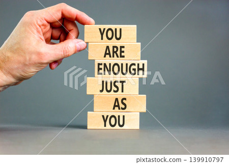 You are enough symbol. Concept words You are enough just as you on beautiful wooden sticks. Beautiful grey background. Business motivational and you are enough just as you concept. Copy space. You are enough symbol. Concept words You are enough just as you on beautiful wooden sticks. Beautiful grey background. Business motivational and you are enough just as you concept. Copy space. 139910797