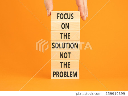 Problem and solution symbol. Concept words Focus on the solution not the problem on beautiful wooden blocks. Beautiful orange paper background. Business problem and solution concept. Copy space. 139910899