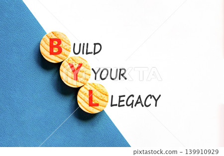 BYL build your legacy symbol. Concept words BYL build your legacy on beautiful wooden circles. Beautiful white blue background. Business BYL build your legacy concept. Copy space 139910929