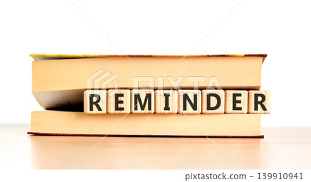 Reminder word symbol. Concept word Reminder on beautiful wooden blocks in beautiful book. Beautiful wooden table white background. Business support help reminder word concept. Copy space. Reminder word symbol. Concept word Reminder on beautiful wooden blocks in beautiful book. Beautiful wooden table white background. Business support help reminder word concept. Copy space. 139910941