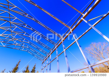 Structure emerging with metal beams framework building frame assembly at construction location Structure emerging with metal beams framework building frame assembly at construction location 139910980