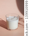 glass of milk on pink background 139910999