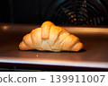 croissant on a Baking Sheet in the oven 139911007