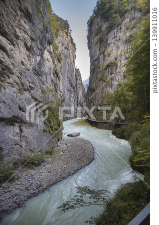 Aare gorge river flowing between high rock cliffs Aare gorge river flowing between high rock cliffs 139911016