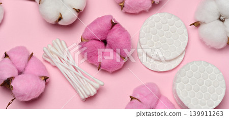 Round cotton pads on a soft pink background, close-up of hygiene products for daily skin care Round cotton pads on a soft pink background, close-up of hygiene products for daily skin care 139911263