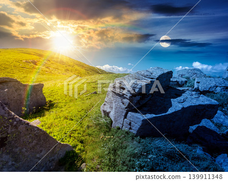 day meet night above Carpathian mountain summer landscape. sun and moon in harmony over meadow with stones among the grass on hillside near the peak of mountain range. alpine meadow and rolling hills day meet night above Carpathian mountain summer landscape. sun and moon in harmony over meadow with stones among the grass on hillside near the peak of mountain range. alpine meadow and rolling hills 139911348