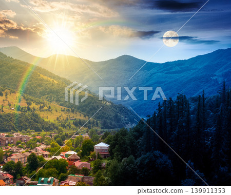 day meet night. carpathian mountain landscape in summer. view in to the valley of rakhiv town near forested hill of mountain range. astrology background of alpine ukraine countryside. harmony concept day meet night. carpathian mountain landscape in summer. view in to the valley of rakhiv town near forested hill of mountain range. astrology background of alpine ukraine countryside. harmony concept 139911353
