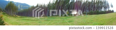 Panoramic view of Beskydy ski slope meadow with tall trees and forested hills Panoramic view of Beskydy ski slope meadow with tall trees and forested hills 139911528