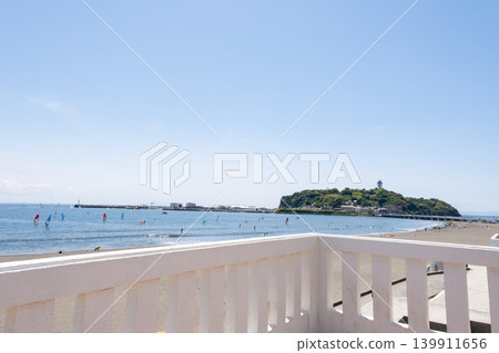 A view of Katase Higashihama and Enoshima from the sidewalk. A view of Katase Higashihama and Enoshima from the sidewalk. 139911656