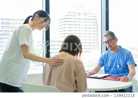 A woman grieves after receiving a diagnosis from her doctor. A woman grieves after receiving a diagnosis from her doctor. 139912118