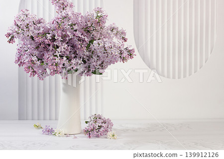Beautiful spring blooming lilac branches in vase on elegant background. Abstract flower arrangement and banner for screen, Still life with place for text, Floral holiday card Beautiful spring blooming lilac branches in vase on elegant background. Abstract flower arrangement and banner for screen, Still life with place for text, Floral holiday card 139912126