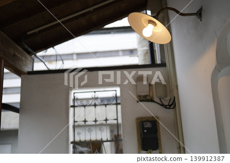 An image of an electricity bill. Retro lighting and a blurred electricity meter. 139912387