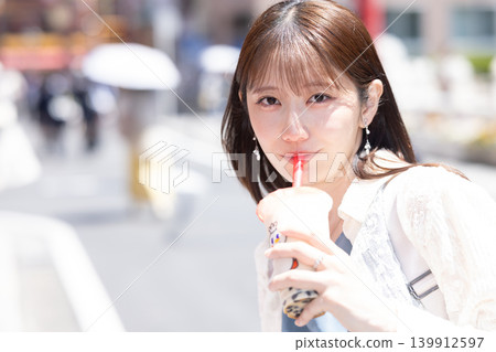 A woman enjoying street food in Yokohama Chinatown A woman enjoying street food in Yokohama Chinatown 139912597