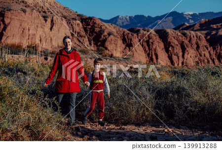 Mother and son walking on mountains background at autumn Mother and son walking on mountains background at autumn 139913288