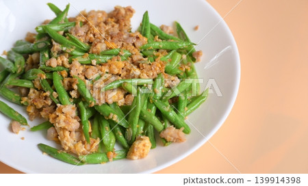 fried green bean with pork on white plate, thai and chinese food fried green bean with pork on white plate, thai and chinese food 139914398