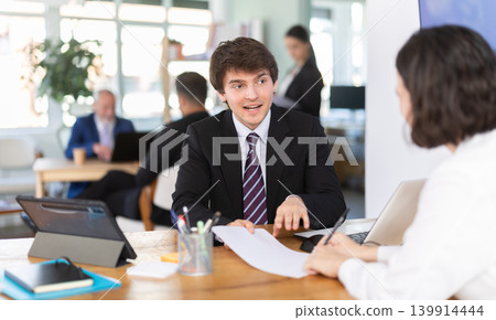 Bank manager tells a woman about profitable deposits and savings accounts 139914444