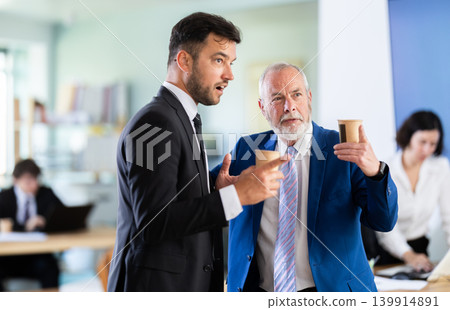 managers of the bank office discuss work issues during a coffee break managers of the bank office discuss work issues during a coffee break 139914891
