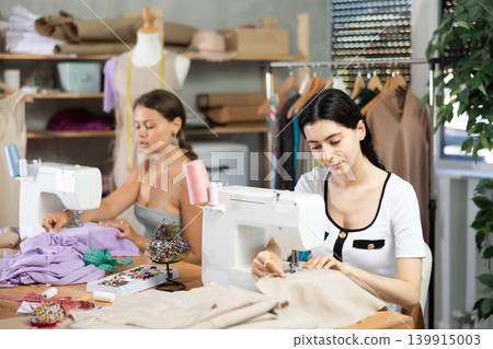 team of dressmakers sewing clothes team of dressmakers sewing clothes 139915003