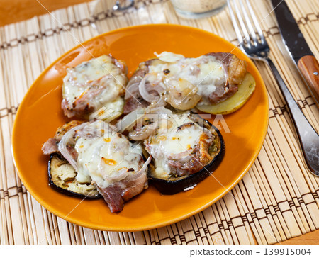 Baked meat on piece of eggplants and potato under cheese Baked meat on piece of eggplants and potato under cheese 139915004
