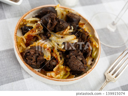 Slices of fried morcilla served with caramelized onions Slices of fried morcilla served with caramelized onions 139915074