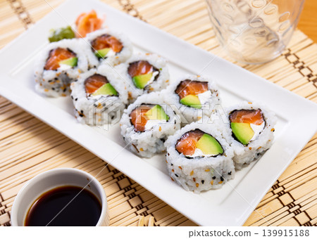 Uramaki roll with salmon, avocado and cream cheese Uramaki roll with salmon, avocado and cream cheese 139915188