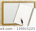 Business idea generation and studying: A ring notebook and ballpoint pen spread out on a wooden-framed whiteboard. 139915225