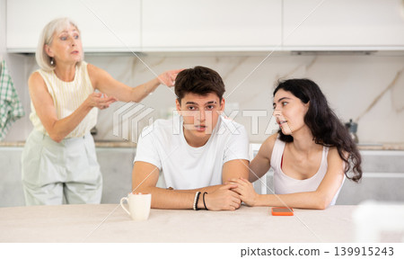 Elderly woman swears at young married couple Elderly woman swears at young married couple 139915243