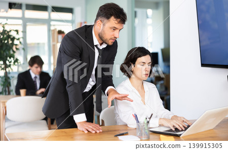 Office employees are working on a project and checking data on a laptop Office employees are working on a project and checking data on a laptop 139915305