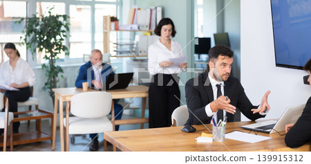 Bank manager talking with male client in office 139915312
