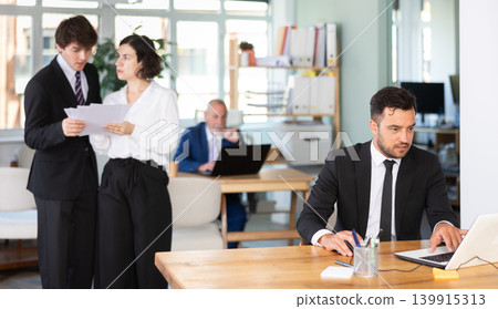 Office employee working on a laptop 139915313