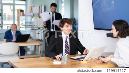 Bank manager talking with female client in office 139915317