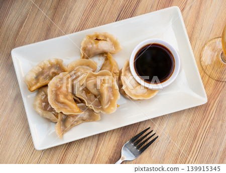 Fried Chinese dumplings served with soy sauce Fried Chinese dumplings served with soy sauce 139915345