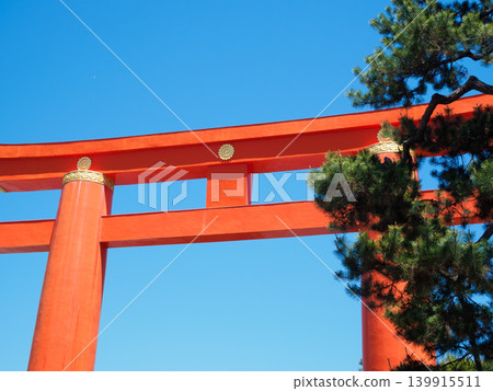 The large torii gate of Heian Jingu Shrine stands out against the blue sky. The large torii gate of Heian Jingu Shrine stands out against the blue sky. 139915511