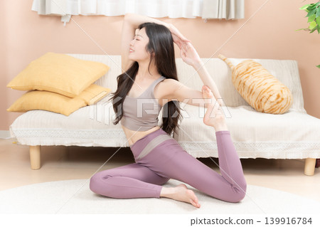 一位年輕女子在房間裡做瑜伽 139916784