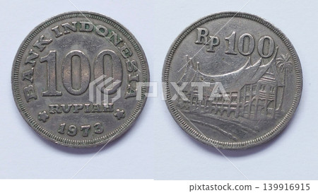 Ancient Indonesian 100 Rupiah Coin from 1973 with a Picture of a Traditional Minangkabau House 139916915