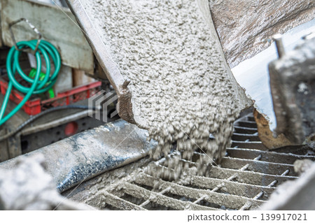Concrete pouring from mixer truck, construction site infrastructure and building industry Concrete pouring from mixer truck, construction site infrastructure and building industry 139917021