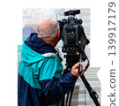 Back view of professional cameraman with professional video camera on tripod filming, isolated on transparent background. High quality photo 139917179