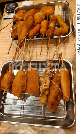Delicious-looking kushikatsu, a specialty of Osaka, served on a metal tray. Delicious-looking kushikatsu, a specialty of Osaka, served on a metal tray. 139917507